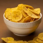 Jaambu Kerala Nendran Banana Chips, Red Onion & Cheese in a ceramic bowl