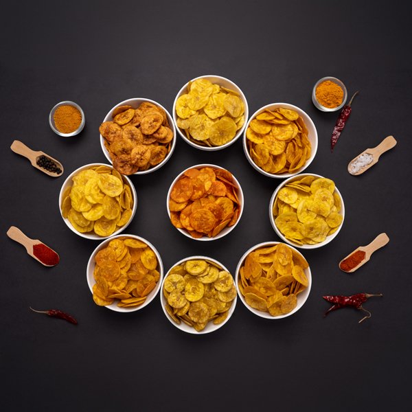 An assortment of Jaambu banana chips in ceramic bowls.